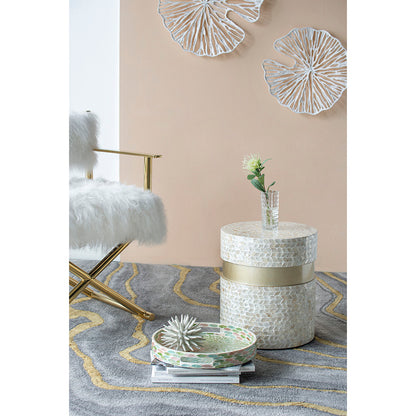 Decorative side table with a textured surface and gold accents in a stylish room - Meen Tribe