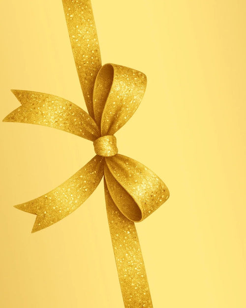 Gold ribbon and bow on a golden background for the Meen Tribe gift card